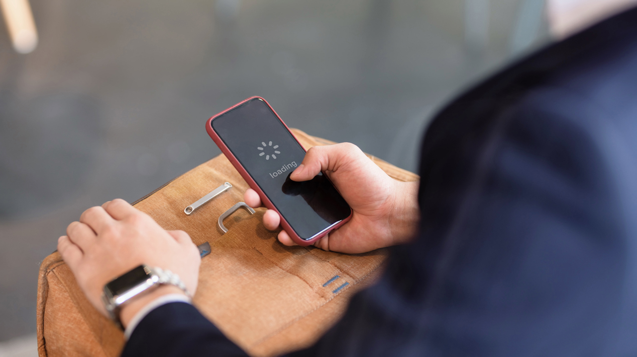 Man holding phone with loading screen